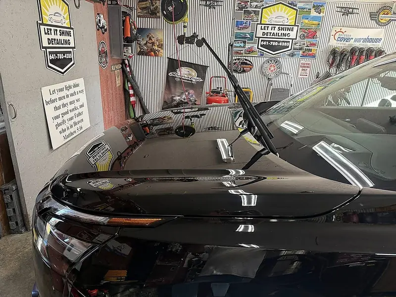 Coated black hood reflecting the shop lights